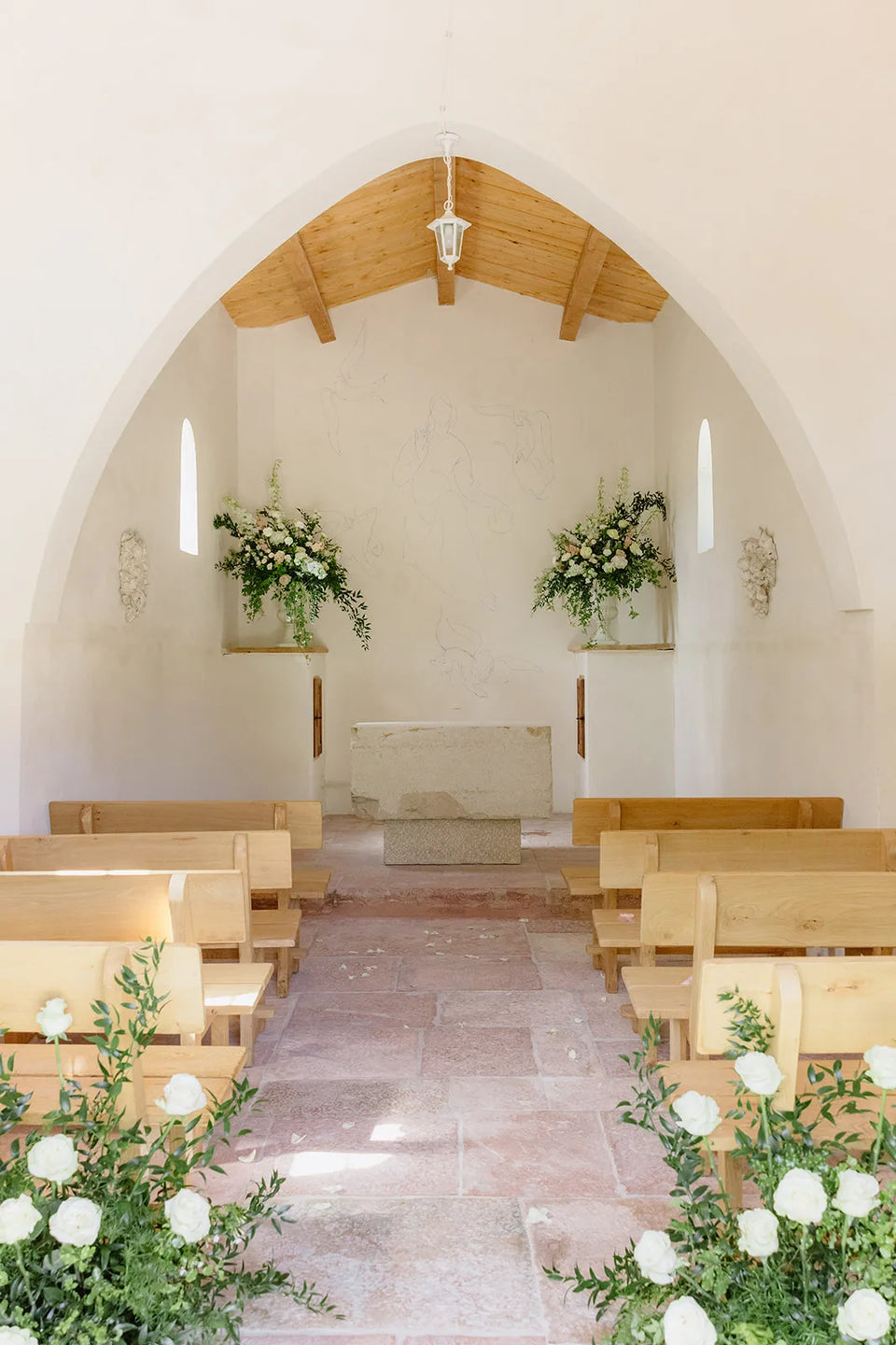 L’intérieur de la chapelle décoré de fleurs blanches — Domaine Fontainebleau en Provence