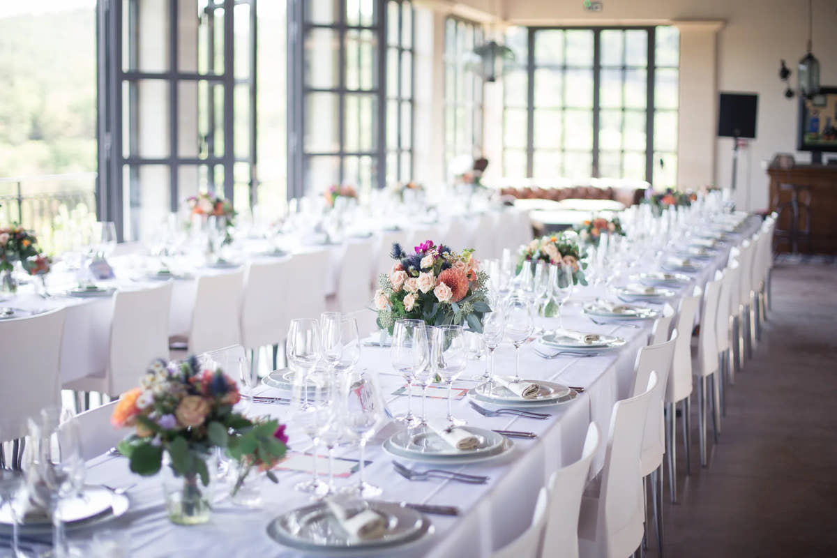 The reception room with long tables laid — Domaine Fontainebleau en Provence