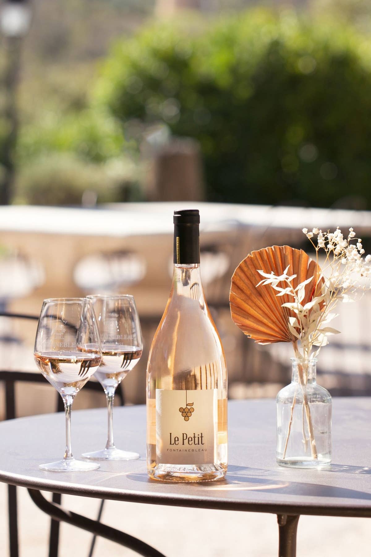 Le Petit Fontainebleau rosé on a terrace table, two glasses poured
